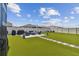Artificial turf backyard with patio and seating area at 9309 Rally Spring Loop, Wesley Chapel, FL 33545