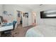 Bedroom with a queen bed, desk, and walk-in closet at 9309 Rally Spring Loop, Wesley Chapel, FL 33545