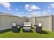 Relaxing backyard with artificial turf and seating area at 9309 Rally Spring Loop, Wesley Chapel, FL 33545