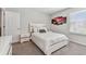 Charming bedroom with white furniture, gray carpet, and a window at 9309 Rally Spring Loop, Wesley Chapel, FL 33545