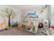 room with a whimsical jungle theme and built in shelving at 9309 Rally Spring Loop, Wesley Chapel, FL 33545