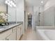 Spa-like bathroom with a double vanity, soaking tub and a glass shower at 9309 Rally Spring Loop, Wesley Chapel, FL 33545
