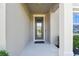 Inviting front door entry with glass accents and a welcoming porch at 9309 Rally Spring Loop, Wesley Chapel, FL 33545