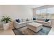 Comfortable living room featuring sectional sofa and large windows at 9309 Rally Spring Loop, Wesley Chapel, FL 33545