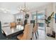 Open concept dining room with modern chandelier and view to backyard at 9309 Rally Spring Loop, Wesley Chapel, FL 33545