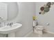 Stylish powder room featuring a pedestal sink and decorative wall art at 9309 Rally Spring Loop, Wesley Chapel, FL 33545