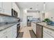 Modern kitchen with stainless steel appliances and granite countertops at 9309 Rally Spring Loop, Wesley Chapel, FL 33545