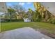 Backyard view showcasing the lush greenery, mature trees, storage shed, and patio area, creating a serene outdoor space at 508 Brooker Rd, Brandon, FL 33511