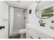 Bathroom with tub and shower featuring marble tile, a white vanity, and a round mirror at 508 Brooker Rd, Brandon, FL 33511