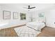 Bedroom with natural light featuring wood flooring, a ceiling fan, and a white bed at 508 Brooker Rd, Brandon, FL 33511