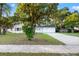 Inviting single-story home featuring a well-manicured lawn and mature trees, adding character to the property at 508 Brooker Rd, Brandon, FL 33511