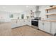 Modern kitchen with white cabinets, wooden countertops, stainless steel appliances and wood-look flooring at 508 Brooker Rd, Brandon, FL 33511