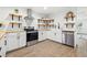 Well-lit kitchen with white cabinetry, open shelving, stainless steel appliances, and wood-look flooring at 508 Brooker Rd, Brandon, FL 33511
