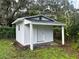 Close-up of storage shed, with covered entry, and a yard view at 508 Brooker Rd, Brandon, FL 33511