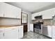 Modern kitchen with white cabinets, wood countertops, and mosaic backsplash at 4320 3Rd N Ave, St Petersburg, FL 33713