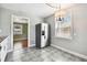 Kitchen features stainless steel refrigerator and view into adjacent living area at 4320 3Rd N Ave, St Petersburg, FL 33713