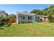 House with teal door, landscaping, and wooden fence at 4320 3Rd N Ave, St Petersburg, FL 33713