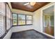 Sunroom with wood ceiling, tile floor and access to the living room at 4320 3Rd N Ave, St Petersburg, FL 33713
