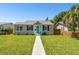 Cute bungalow with teal door, landscaping, and walkway at 4320 3Rd N Ave, St Petersburg, FL 33713