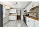 Updated kitchen with white cabinets, wood countertops, and stylish lighting at 4320 3Rd N Ave, St Petersburg, FL 33713