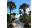 White sand pathway leads to the beach through lush tropical landscaping at 4320 3Rd N Ave, St Petersburg, FL 33713