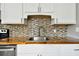 Kitchen sink and countertop detail showcasing wood countertop and mosaic backsplash at 4320 3Rd N Ave, St Petersburg, FL 33713