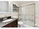 Bathroom with dark vanity, white tile and shower at 4320 3Rd N Ave, St Petersburg, FL 33713