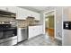 Modern kitchen with stainless steel appliances and view into living room at 4320 3Rd N Ave, St Petersburg, FL 33713