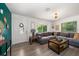 Spacious living room with sectional sofa and wood-look floors at 6199 59Th N Pl, St Petersburg, FL 33709