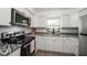 Modern kitchen with white cabinets and granite countertops at 6199 59Th N Pl, St Petersburg, FL 33709