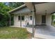 House exterior showcasing the front entrance and carport at 6199 59Th N Pl, St Petersburg, FL 33709