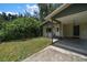 Front view of the house with a covered carport and landscaping at 6199 59Th N Pl, St Petersburg, FL 33709
