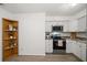 Updated kitchen with white cabinets and granite countertops at 6199 59Th N Pl, St Petersburg, FL 33709