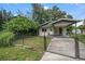 Charming house exterior with a covered carport and well-maintained lawn at 6199 59Th N Pl, St Petersburg, FL 33709