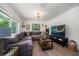 Cozy living room featuring a large sectional sofa and TV at 6199 59Th N Pl, St Petersburg, FL 33709