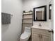 Simple bathroom with white vanity and black framed mirror at 6199 59Th N Pl, St Petersburg, FL 33709