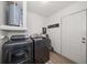 Well-lit laundry room, complete with washer, dryer, and extra storage at 6199 59Th N Pl, St Petersburg, FL 33709