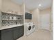 Laundry room with washer, dryer, and stylish cabinetry at 9249 Highland Hills Dr, Hudson, FL 34667