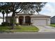 Single-story house with two-car garage and landscaped yard at 10312 Cleghorn Dr, San Antonio, FL 33576