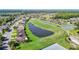 Picturesque aerial shot of homes near a well-kept golf course and a beautiful pond at 11247 Corey Pavin Ln, San Antonio, FL 33576