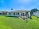 Beautiful backyard featuring a lush green lawn, patio area, and a well-maintained exterior at 11247 Corey Pavin Ln, San Antonio, FL 33576