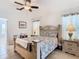 Bedroom featuring a decorative headboard, tiled flooring, and two windows with privacy blinds at 11247 Corey Pavin Ln, San Antonio, FL 33576