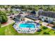 Aerial view of the fenced community pool with lounge chairs and umbrellas at 11247 Corey Pavin Ln, San Antonio, FL 33576