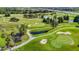 Picturesque aerial shot of a meticulously maintained golf course with multiple sand traps at 11247 Corey Pavin Ln, San Antonio, FL 33576