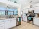Spacious kitchen with stainless steel appliances, granite counters and bar, open to living area at 11247 Corey Pavin Ln, San Antonio, FL 33576