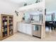 View of kitchen with dishwasher, granite countertops, and view into open concept living area at 11247 Corey Pavin Ln, San Antonio, FL 33576