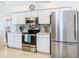 Well-lit kitchen featuring stainless steel appliances, granite countertops and attractive backsplash at 11247 Corey Pavin Ln, San Antonio, FL 33576