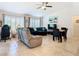Open living room area with tile floors, ceiling fan, and lots of natural light at 11247 Corey Pavin Ln, San Antonio, FL 33576