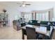 Open living room area with tile floors, ceiling fan, and lots of natural light at 11247 Corey Pavin Ln, San Antonio, FL 33576