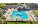 Overhead view of the community's recreational area with uniquely shaped pool, palm trees and lounge chairs at 11247 Corey Pavin Ln, San Antonio, FL 33576